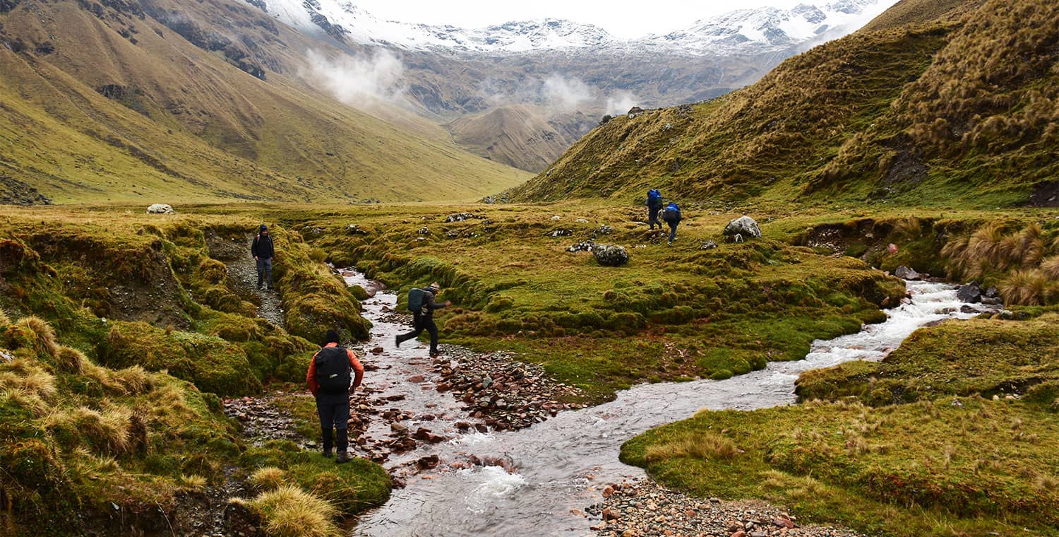 Hikers trekking near Salkantay Mountain vs Lares Trail on a Cusco adventure