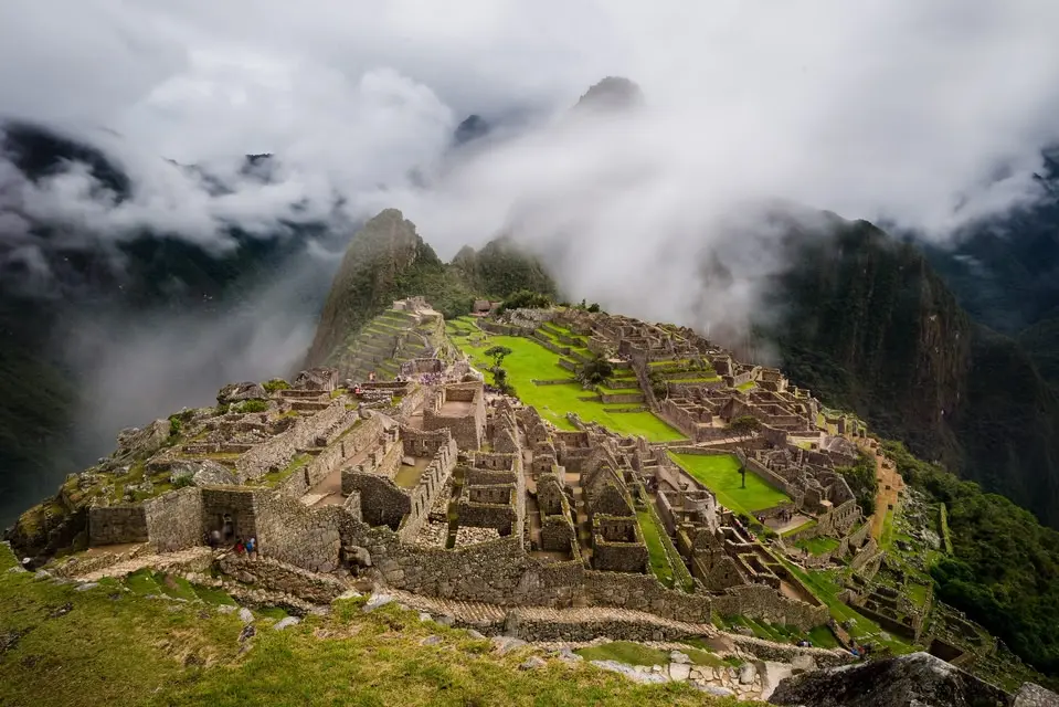 Ancient Inca citadel emerging from morning mist on the final day of the mountain trek