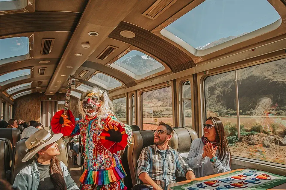 Peru Rail Vistadome panoramic train carriage moving through green Andean valley