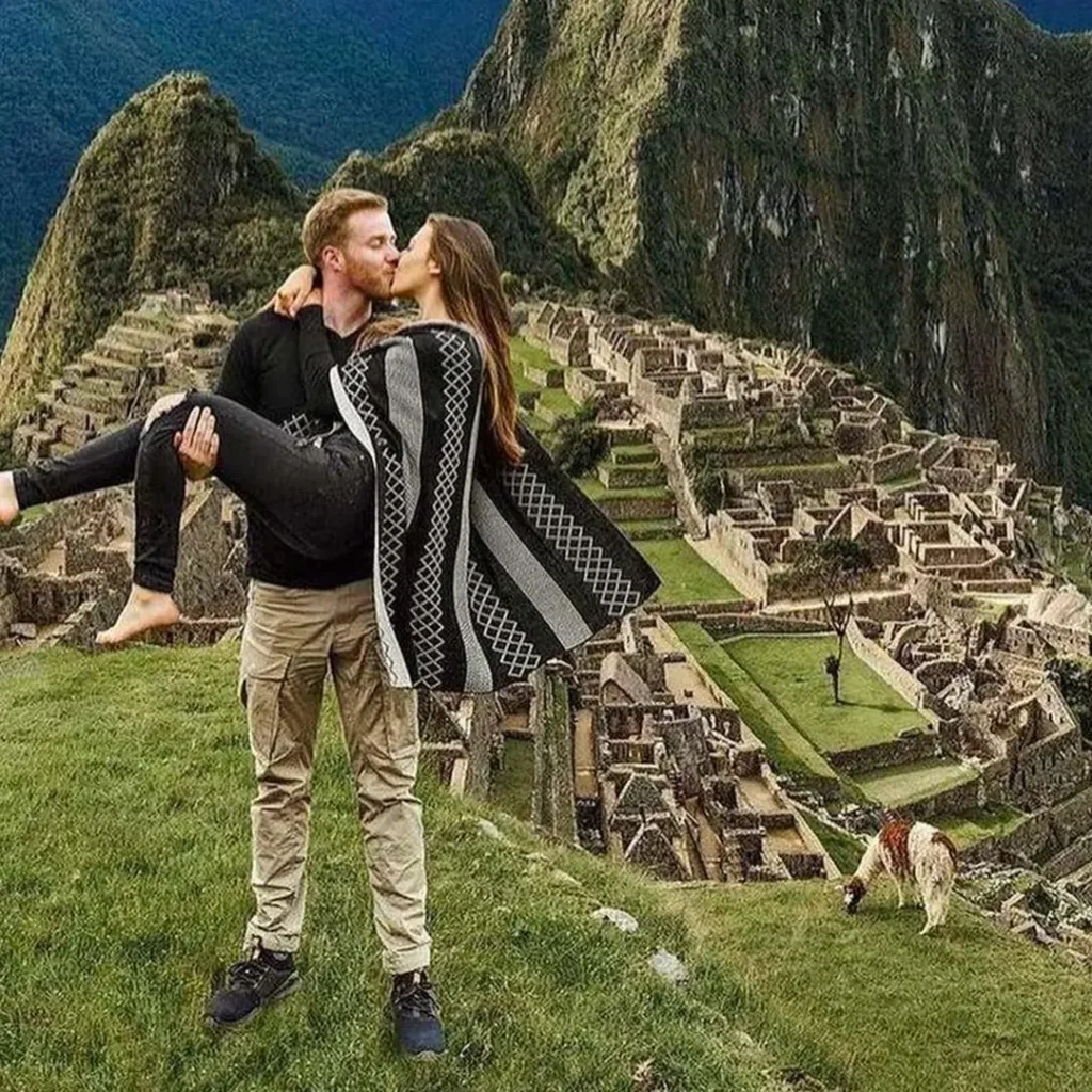 Machu Picchu luxury tours happy couple at the Sun Gate with citadel panorama